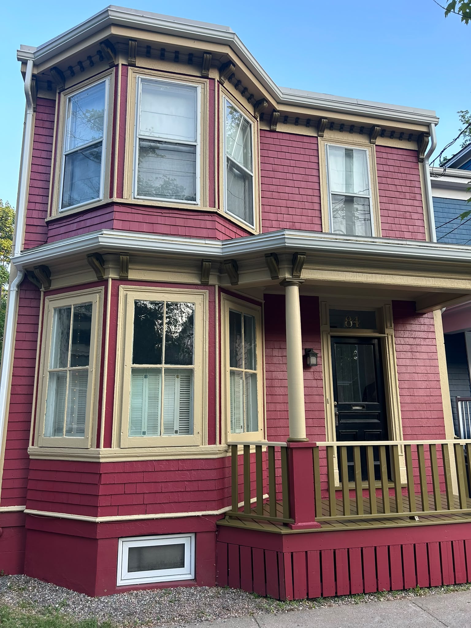 Raspberry shingle exterior with cream trim and olive accents